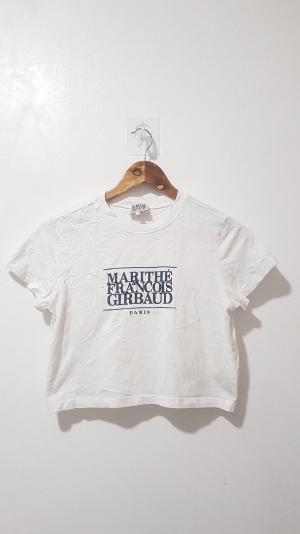 Marithe Francois Girbaud Paris White T-Shirt Size S (Category: Shirts) located in Manila. Submitted by nice430 (Listing ID 1467295948, Image 1). Description: - Brand: Marithé François Girbaud - Color: Clean White with Bold Black Box Logo - Size: S (Best fit for height: 155-160cm, Bust: 80-86cm) - Material: 100% Premium Cotton - Design: Classic crew neck, short sleeves - Condition: Brand new with interior brand tags and care label - Style: Versati