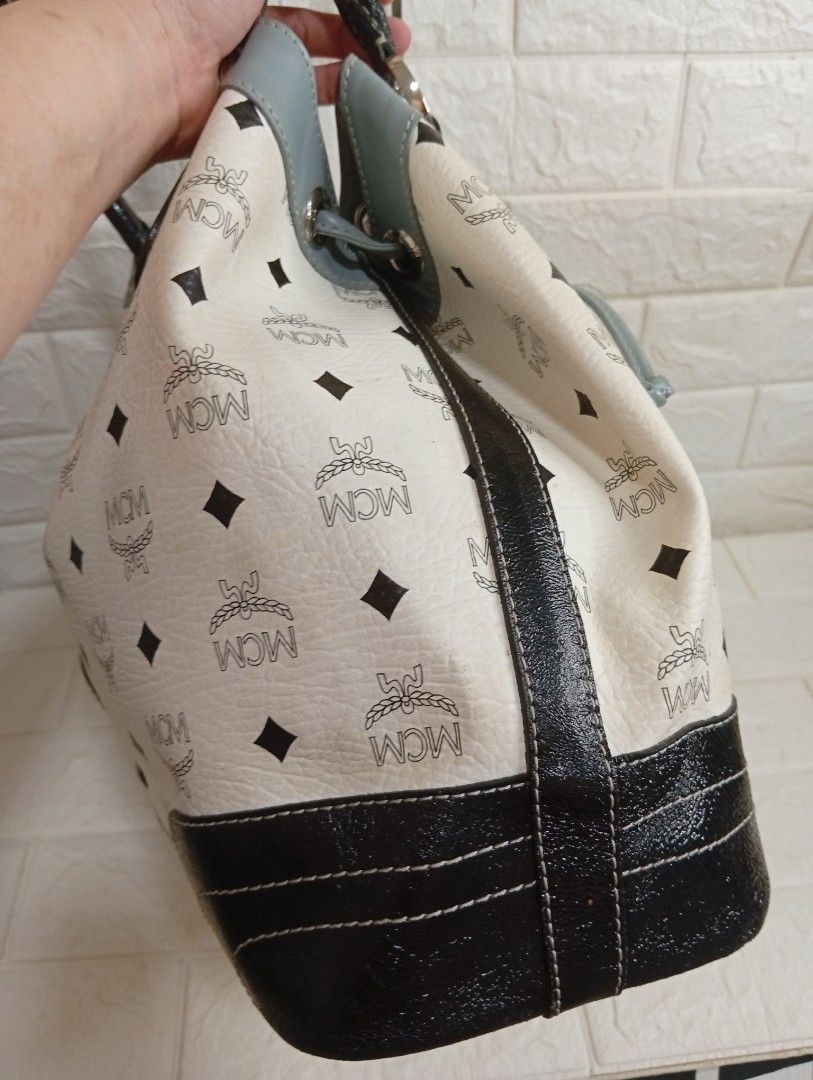 MCM Monogram Print Shoulder Bag Bucket Bag (Category: Shoulder Bags) located in Las Pinas. Submitted by etoksi1234 (Listing ID 1467224338, Image 3). Description: Pre-loved MCM monogram white tote bag with black and grey leather accents, dual top handles, and a secure drawstring closure. Features a spacious interior and structured base—perfect for daily use or travel..