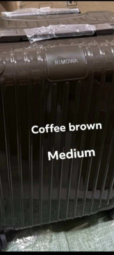 Medium Coffee polycarbonate Brown Suitcase (Category: Luggage) located in Manila. Submitted by dh3nz1 (Listing ID 1467175497, Image 1). Description: - Authentic Rimowa medium-sized suitcase - Glossy coffee brown hard shell with iconic vertical grooves - Smooth-gliding multi-wheel setup for effortless mobility - Top and side grab handles wrapped in original protective plastic - Signature centered Rimowa brand badge - Secure zipper closure system -