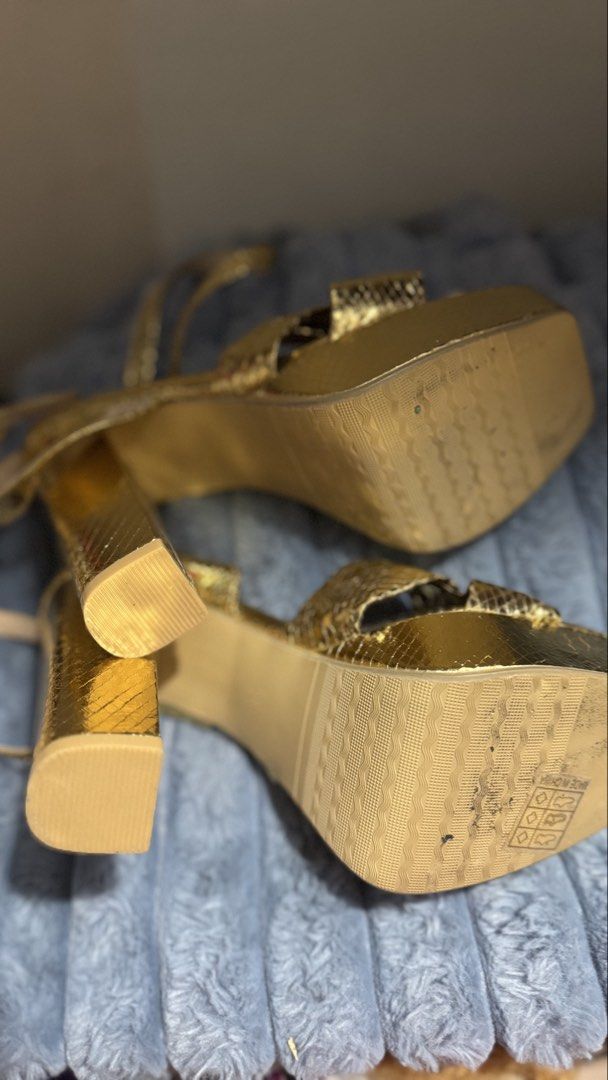 Metallic Gold Snake Print Platform Block Heels (Category: Heels) located in Manila. Submitted by darslovesfoods (Listing ID 1467189437, Image 3). Description: - Color & Texture: Metallic gold with a chic snakeskin finish - Heel & Sole: Comfortable chunky block heel with a supportive platform sole - Design: Stylish square toe with an adorable front knot detail - Closure: Adjustable ankle strap with buckle - Condition: Light wear on the bottom sole