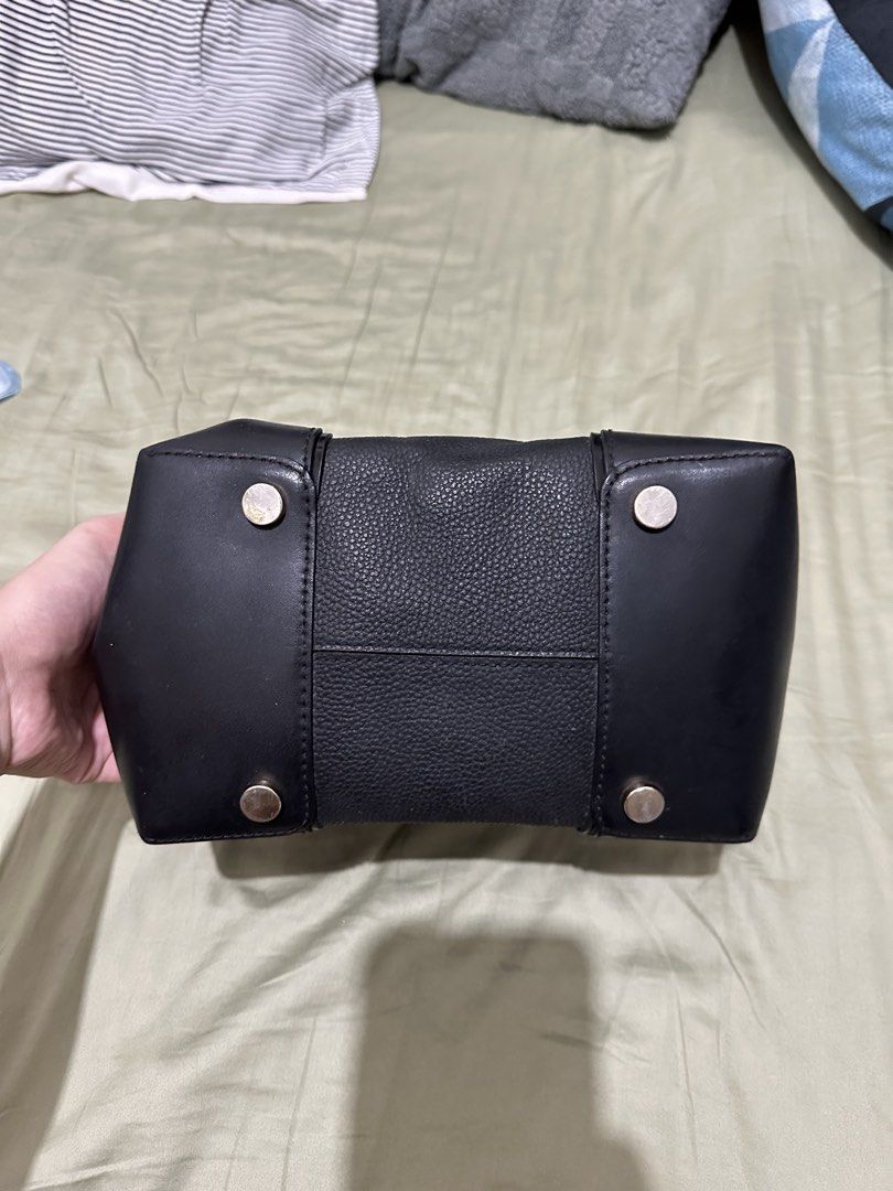 Michael Kors Black Leather Bucket Bag (Category: Luxury Bags & Wallets) located in Santa Rosa. Submitted by babicdln (Listing ID 1467312671, Image 3). Description: - Brand: Michael Kors - Material: Black pebbled leather with smooth leather bottom corner reinforcements - Hardware: Gold-tone lettering and metallic drawstring tips - Closure: Top drawstring closure - Capacity: Compact daily carry, easily fits phone, wallet, and keys with extra interi