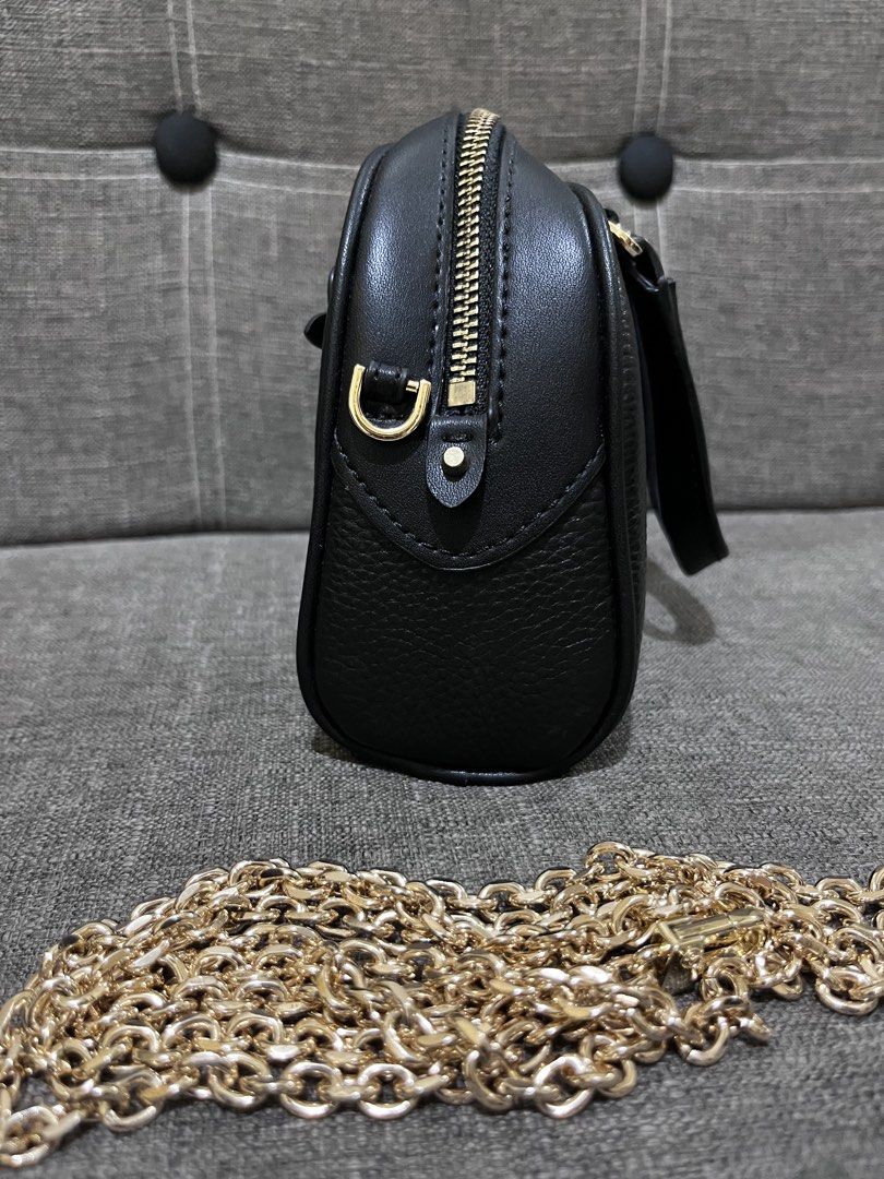 Michael Kors Black Sling chain bag (Category: Luxury Bags & Wallets) located in Manila. Submitted by zencat.93bfa9 (Listing ID 1467315905, Image 3). Description: - Brand: Michael Kors - Material: Black pebble leather with gold hardware - Features: Top handles, front zip pocket, and main zip closure - Strap: Includes a detachable chunky gold chain strap - Interior: Fabric-lined with a compact size for daily essentials - Condition: excellent, barel