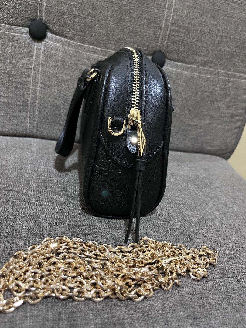 Michael Kors Black Sling chain bag (Category: Luxury Bags & Wallets) located in Manila. Submitted by zencat.93bfa9 (Listing ID 1467315905, Image 2). Description: - Brand: Michael Kors - Material: Black pebble leather with gold hardware - Features: Top handles, front zip pocket, and main zip closure - Strap: Includes a detachable chunky gold chain strap - Interior: Fabric-lined with a compact size for daily essentials - Condition: excellent, barel