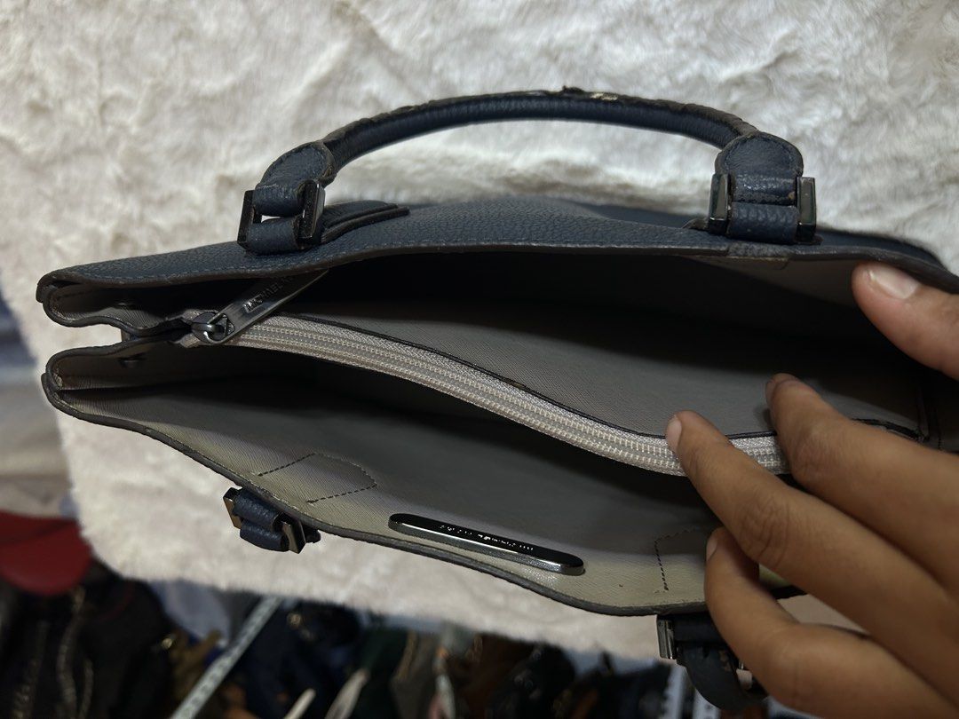 Michael Kors Blue Leather Tote Handbag (Category: Tote Bags) located in Valencia. Submitted by carmzfindsph (Listing ID 1467204243, Image 3). Description: - Brand: Michael Kors - Color: Dark Blue - Material: Premium textured leather - Hardware: Silver-tone - Closure: Magnetic top closure - Handles: Sturdy top handles - Exterior Detail: Signature hanging padlock charm on the front - Interior Details: Spacious with a central zip compartment and cle