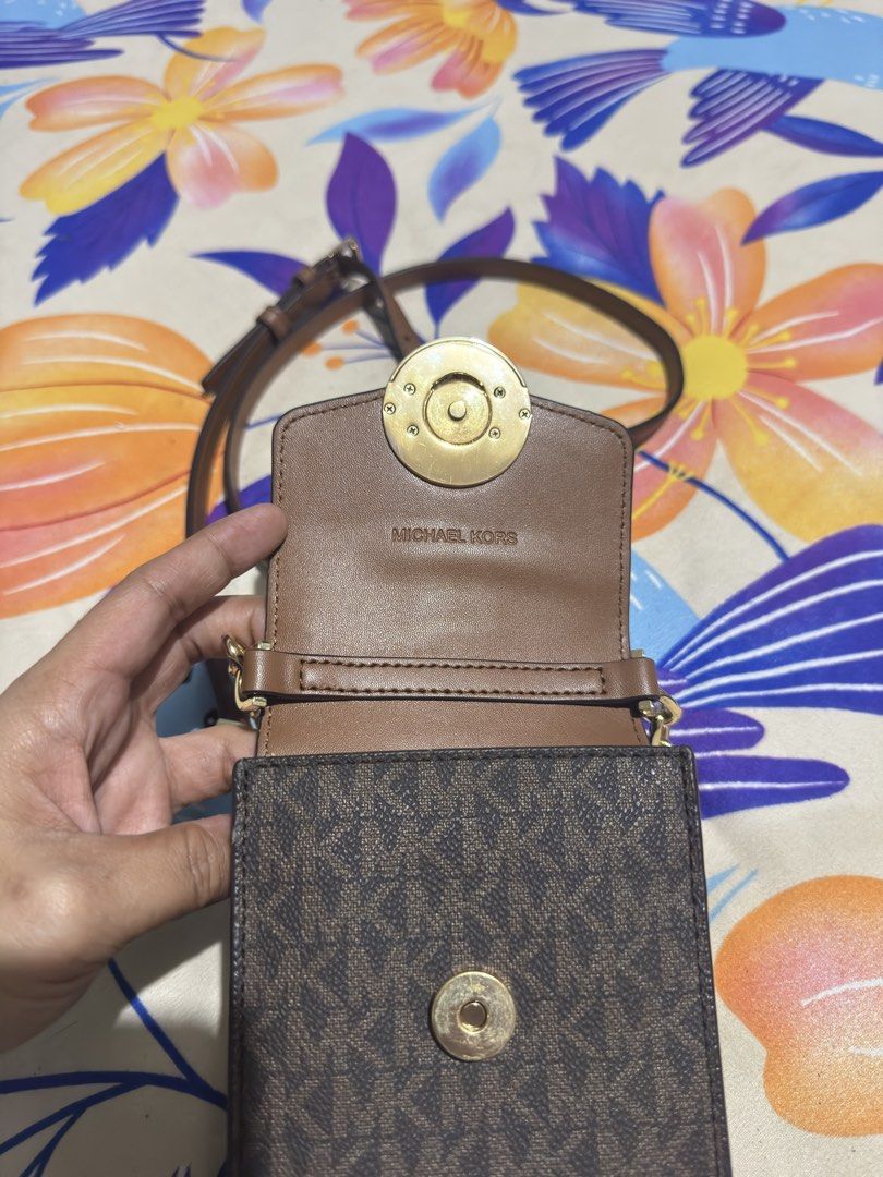 Michael Kors Brown MK Monogram Phone Crossbody Bag (Category: Luxury Bags & Wallets) located in Manila. Submitted by piayee (Listing ID 1467275021, Image 2). Description: - Authentic Michael Kors phone crossbody bag - Brown monogram print with solid brown leather flap - Elegant gold-tone hardware with prominent MK circle logo snap closure - Secure magnetic snap main closure and inner snap button - Adjustable brown leather strap featuring stylish 