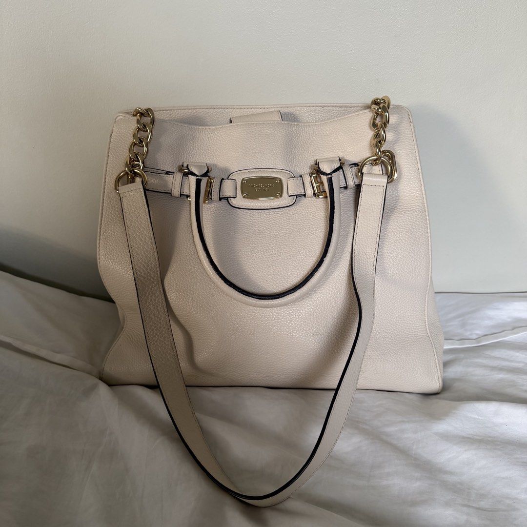Michael Kors Cream Pebble Leather Tote Shoulder Bag (Category: Luxury Bags & Wallets) located in Cebu City. Submitted by bitten_ (Listing ID 1467213321, Image 1). Description: - Brand: Michael Kors - Material: Cream pebble leather with gold hardware - Design: Signature MK front plaque, double top handles, and chic chain-link shoulder straps - Interior: MK fabric lining with a secure middle zippered compartment, slip pockets, and snap closure stra