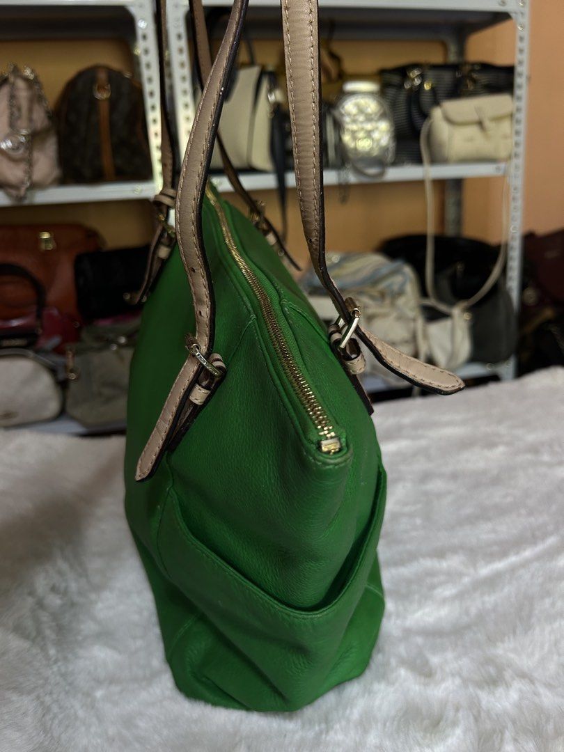 Michael Kors Green Leather Tote Bag (Category: Luxury Bags & Wallets) located in Valencia. Submitted by carmzfindsph (Listing ID 1467222513, Image 3). Description: - Brand: Michael Kors - Material: Bright green pebbled leather - Straps & Hardware: Beige double shoulder straps with gold-tone hardware - Closure: Secure zip-top closure - Interior: Light beige logo print fabric lining with multiple slip pockets and a zippered compartment - Exterior: 