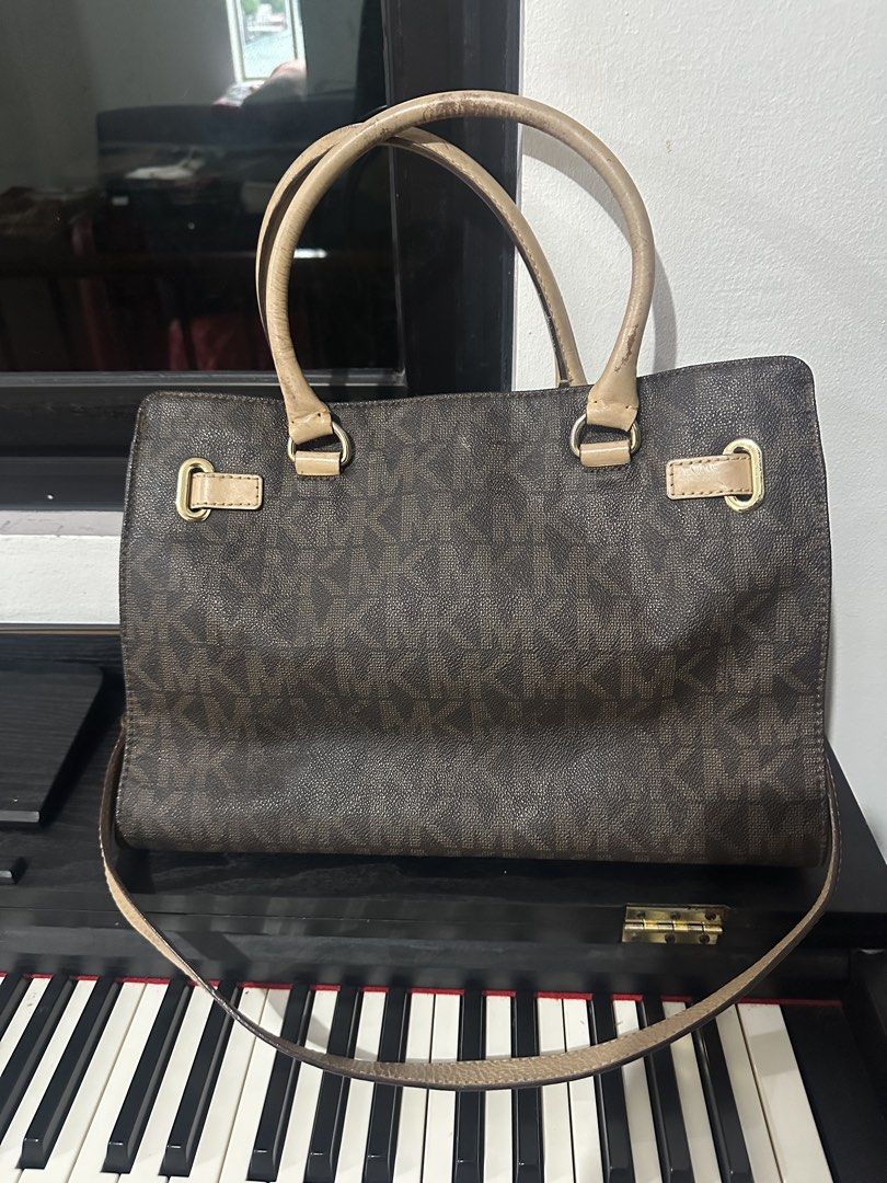 Michael Kors MK Monogram Tote Bag (Category: Luxury Bags & Wallets) located in Marikina City. Submitted by cheszam (Listing ID 1467202985, Image 1). Description: - Brand: Michael Kors - Style: Signature brown MK monogram canvas tote - Hardware: Gold-tone with front logo plaque and buckle detailing - Straps: Double beige leather top handles and a matching long shoulder strap - Interior: Spacious compartments for all your daily essentials - Conditi