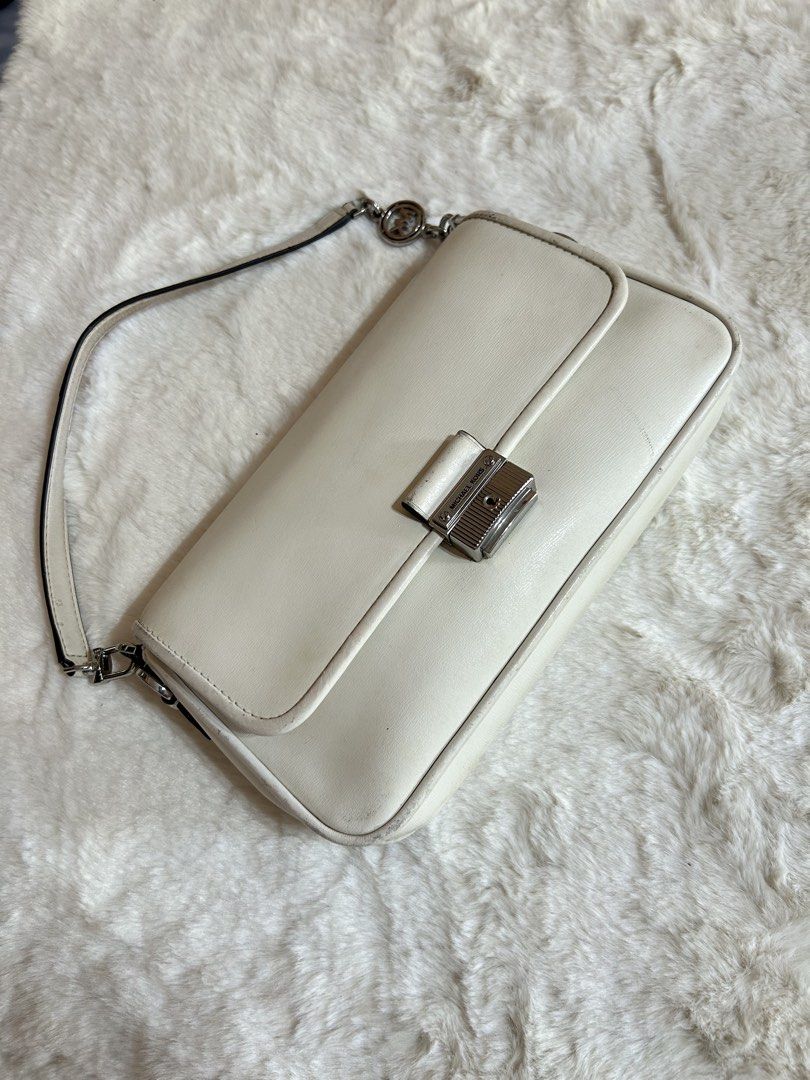 Michael Kors White Shoulder Bag (Category: Shoulder Bags) located in Valencia. Submitted by carmzfindsph (Listing ID 1467206797, Image 1). Description: - Brand: Michael Kors - Color: White with silver-tone hardware - Closure: Front flap with lock clasp - Strap: Single strap accented with a logo charm - Interior: Fabric-lined with a convenient zipped pocket and brand tag - Condition: Pre-loved with visible scuffs and dirt marks on the white leathe