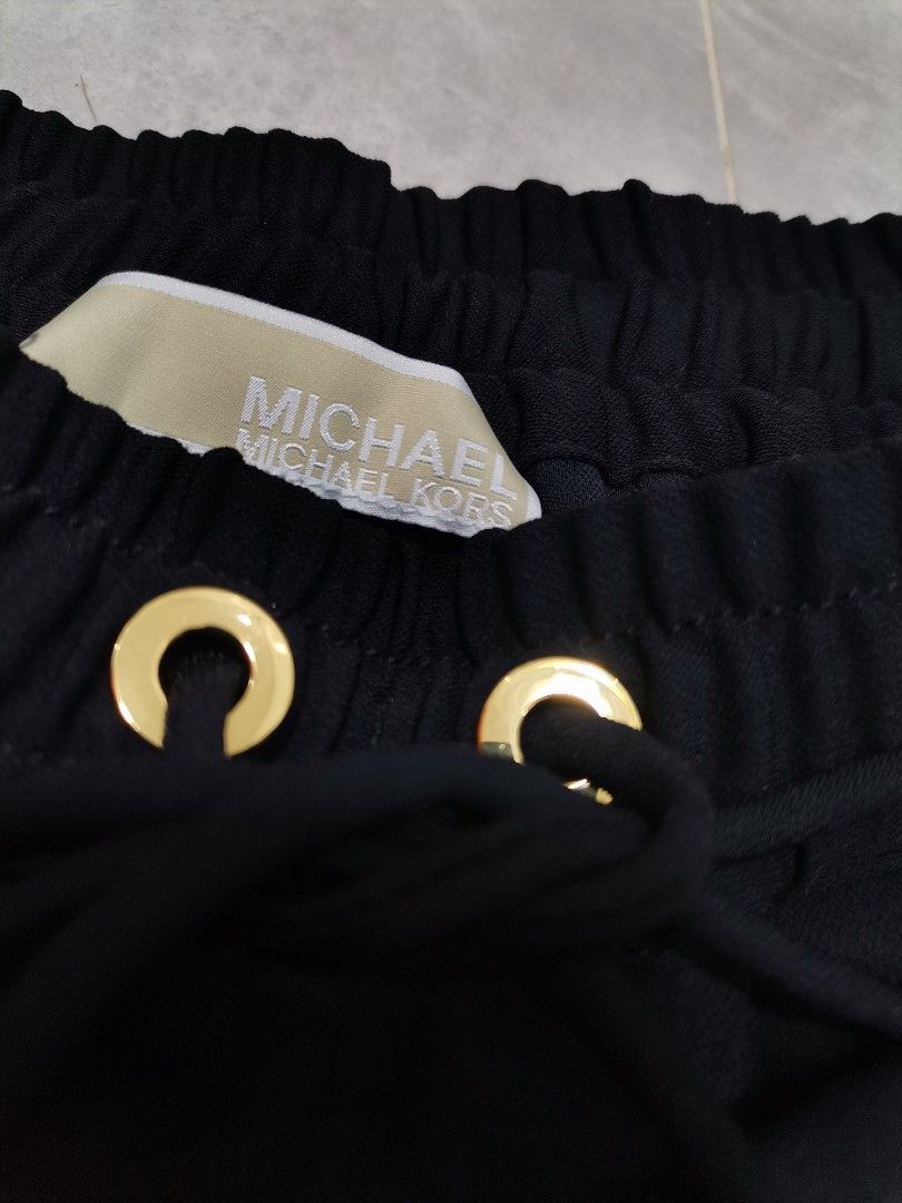MICHAEL MICHAEL KORS Jogger Pants.* (Category: Other Bottoms) located in Iba. Submitted by selector_items (Listing ID 1467192547, Image 3). Description: MICHAEL MICHAEL KORS Jogger Pants.* 1. *Main tag:* The beige `MICHAEL MICHAEL KORS` woven tag inside the waistband - correct font, correct stitching. 2. *Hardware:* This is the best proof. - Gold grommets / eyelets are thick and heavy, not thin plastic - Drawstring tips / aglets are engraved `MIC