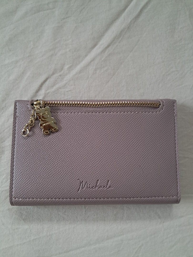 MICHAELA Wallet (Category: Wallets & Card holders) located in Valenzuela. Submitted by famsbest (Listing ID 1467230838, Image 1). Description: - MICHAELA lilac wallet - Premium textured faux leather - Closure: Secure snap button - With multiple card slots, clear ID window, and spacious cash compartment - Lightly used.