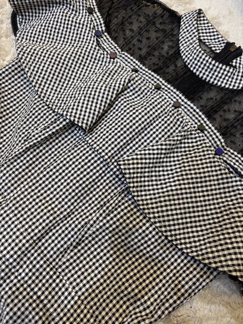 Midnight Gingham Belle (Category: Dresses) located in Batangas. Submitted by nicki0001 (Listing ID 1467249538, Image 3). Description: 🖤 ITEM: Midnight Gingham Belle * Black and white gingham print with a statement ruffle overlay * Sheer mesh neckline with a unique sparkly detail * Thick fabric, back zipper, and pockets on both sides Giving classy Korean doll vibes. Pair it with Mary Janes, a mini handbag, and dainty earrings for that chic, femin