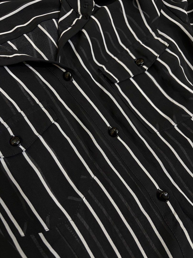 Midnight Pinstripe Dress (Category: Dresses) located in Batangas. Submitted by nicki0001 (Listing ID 1467251447, Image 3). Description: 🖤 ITEM: Midnight Pinstripe Dress * Black sheer shirt dress with classic white pinstripes * Button-down front, long sleeves, and working pockets * Longer back for a relaxed, flowy look * Needs an inner top and slip for coverage Chic and effortlessly classy. Pair it with a black inner dress, strappy sandals, and a