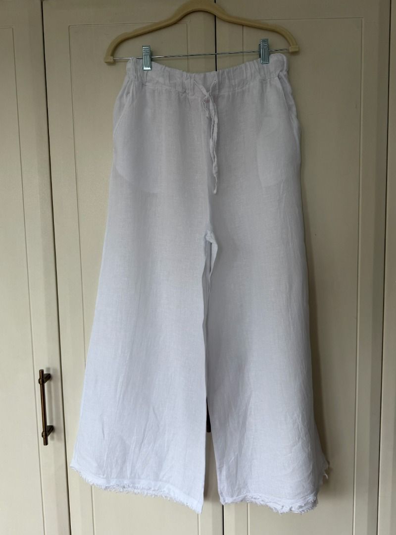 Millenium White Linen Wide Leg Pants Drawstring (Category: Other Bottoms) located in Caloocan City. Submitted by belizalde4 (Listing ID 1467209252, Image 1). Description: - Brand: Millenium - Color: White - Style: Casual wide leg pants - Material: Lightweight linen, perfect for warm weather - Waistband: Elastic with adjustable drawstring tie - Pockets: Two functional side pockets - Details: Trendy raw frayed hem on both legs.