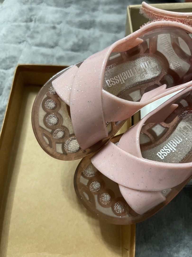 Mini Melissa Friendly BB Clear Pink Glitter Sandals USA 7 (Category: Babies & Kids Fashion) located in Lipa City. Submitted by kissesann (Listing ID 1467298213, Image 3). Description: - Brand: Mini Melissa (Made in Brazil) - Model: Friendly BB - Color: Clear Pink Glitter - Size: USA 7 - Material: Soft jelly with bubble texture footbed - Design: Cross-strap with adjustable velcro ankle strap - Inclusions: Original box included - Condition: Excelle