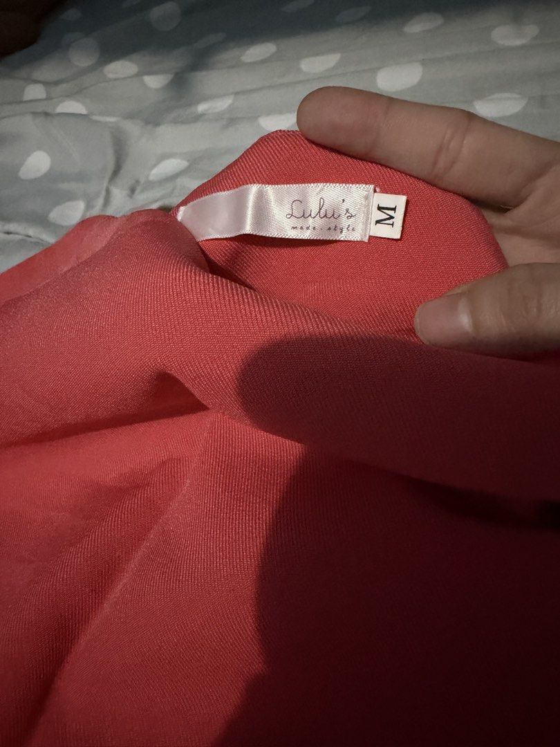 Mini skirt Orange (Category: Skirts) located in Sorsogon. Submitted by jaasss_ (Listing ID 1467292134, Image 2). Description: - Brand: Lulu's -with Lining - Size: Medium (label attached) - Color: Bright coral pink/oranger (vibrant solid shade) - Style: Simple straight cut with clean hem stitching - Condition: Clean, excellent overall with no obvious flaws - Perfect for: Casual day out, easily paired with basic tops or blouses.