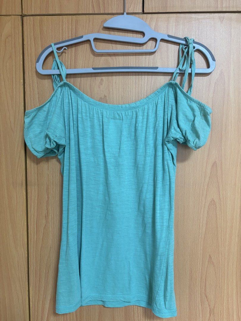 Mint Green Cold Shoulder Off Shoulder Top (Category: Sleeveless) located in Angeles City. Submitted by slimshadee (Listing ID 1467169520, Image 2). Description: - Color: Mint green - Material: Soft and comfortable cotton knit - Design: Short sleeves, spaghetti straps, and slouchy neckline with gathering - Details: Cold shoulder cutouts with adjustable tie straps on the shoulders - Fit: Hip-length, relaxed silhouette - Styling: Great for everyday 