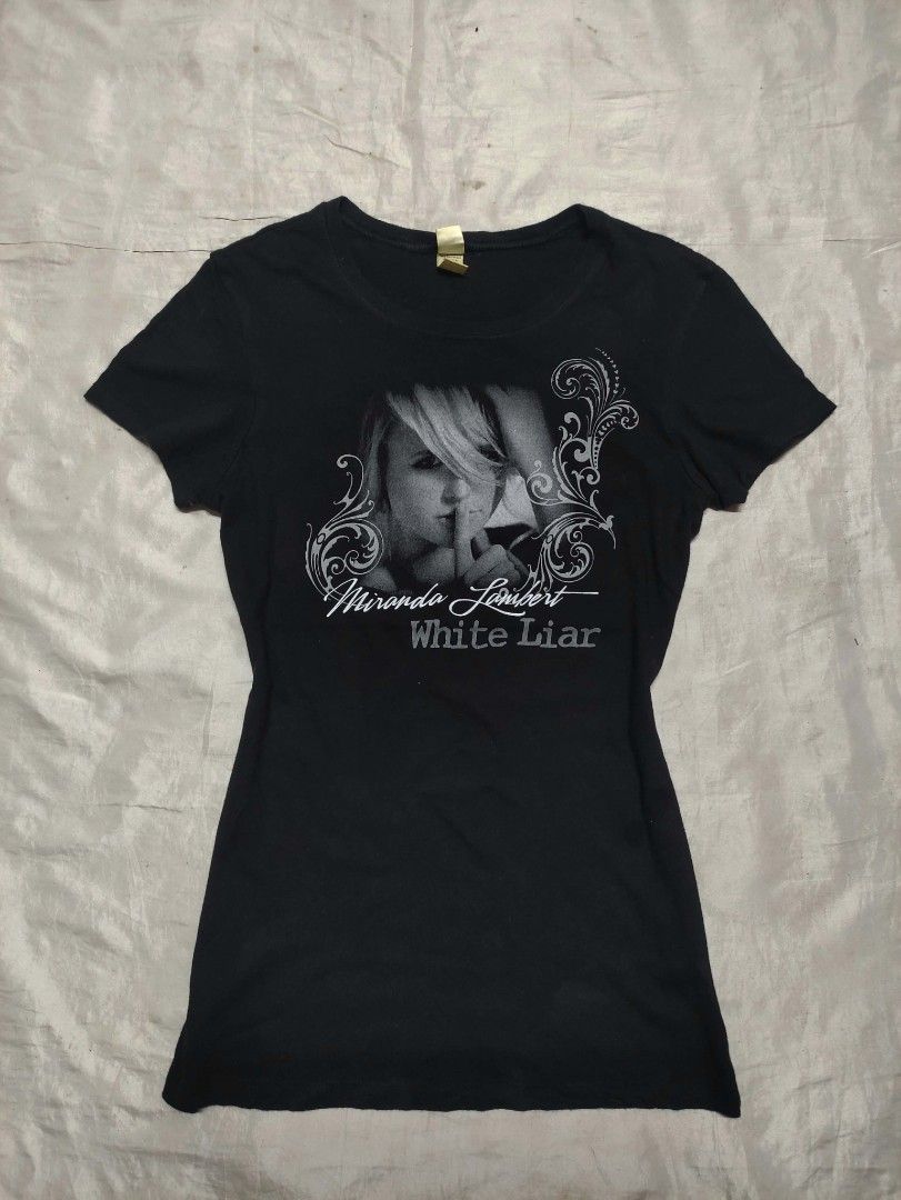 Miranda Lambert White Liar Graphic T-Shirt (Category: Shirts) located in Binan City. Submitted by myks_thrift (Listing ID 1467358949, Image 1). Description: - Official Miranda Lambert White Liar tour merchandise - Color: Black short sleeve top - Graphic print on front with lyrics on the back - Size: Medium (Slim fit cut) - Material: 100% combed cotton (Kavio brand tag) - Care: Machine washable - Made in Vietnam.