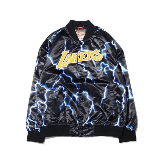 Mitchell & Ness Los Angeles Lakers Lightning Satin Jacket (Category: Coats, Jackets and Outerwear) located in Manila. Submitted by capusojohn43359 (Listing ID 1467180021, Image 1). Description: - Official Hardwood Classics tag - Black satin finish with bold blue lightning bolt pattern - Yellow and white embroidered Lakers script logo on chest - Classic snap button closure - Ribbed black cuffs, collar, and hem for a snug fit - Condition: Brand new