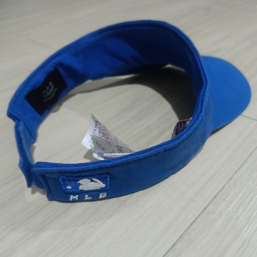 MLB Los Angeles Dodgers Blue Visor Cap (Category: Caps & Hats) located in Manila. Submitted by ghello99 (Listing ID 1467267682, Image 3). Description: - Authentic MLB visor in a bright royal blue color - Features embroidered white LA logo on the front - Adjustable velcro back strap with embroidered MLB batterman logo - Stylish contrast stitching on the brim - Includes interior Major League Baseball text tag, size tag, and care instructions.