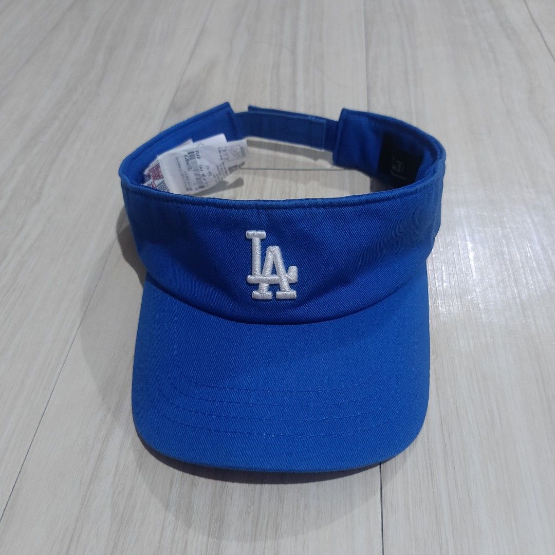 MLB Los Angeles Dodgers Blue Visor Cap (Category: Caps & Hats) located in Manila. Submitted by ghello99 (Listing ID 1467267682, Image 1). Description: - Authentic MLB visor in a bright royal blue color - Features embroidered white LA logo on the front - Adjustable velcro back strap with embroidered MLB batterman logo - Stylish contrast stitching on the brim - Includes interior Major League Baseball text tag, size tag, and care instructions.