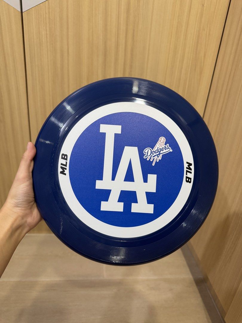 MLB Los Angeles Dodgers Frisbee (Category: Other Sports Equipment and Supplies) located in Taguig. Submitted by chinitafinds (Listing ID 1467258760, Image 1). Description: - Official MLB merchandise: Los Angeles Dodgers flying disc - Color: Dark blue with classic white LA logo - Condition: Brand new, enclosed in original clear drawstring carrying bag - Includes original barcode sticker - Perfect for Dodgers fans, outdoor games, park days, or as a