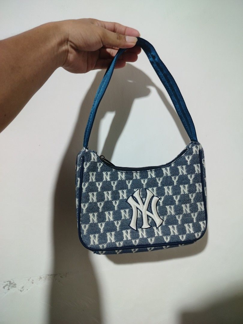 MLB New York Yankees Monogram Denim Shoulder Bag (Category: Shoulder Bags) located in Clarin. Submitted by thriftfinds.2026 (Listing ID 1467279033, Image 1). Description: - Authentic MLB New York Yankees shoulder bag - Premium dark blue denim with all-over NY monogram print - Large white embroidered Yankees logo on the front - Official MLB logo patch on the back - Secure top zipper closure with silver metal pull - Comfortable single blue strap fo