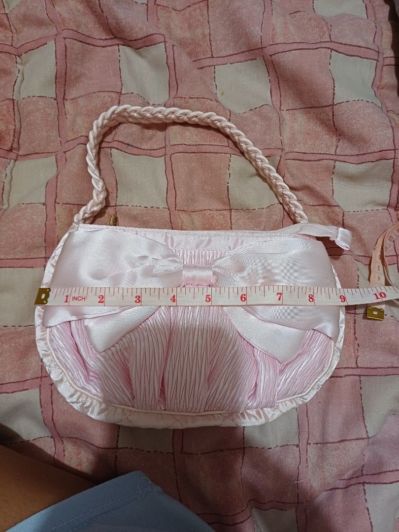 NaRaYa Pink Satin Handbag with Bow (Category: Shoulder Bags) located in San Pedro. Submitted by purpledream0316 (Listing ID 1467319188, Image 2). Description: - Brand: NaRaYa - Material: Soft pink satin with clean fabric - Design: Cute front bow, gathered texture, and braided handle - Closure: Top zipper with gold-tone NaRaYa pull tag - Dimensions: Approximately 6 inches tall x 10 inches wide - Condition: Excellent, clean and ready to use - Best 