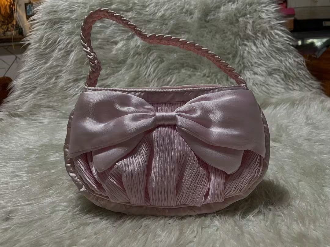 NaRaYa Pink Satin Handbag with Bow (Category: Shoulder Bags) located in San Pedro. Submitted by purpledream0316 (Listing ID 1467319188, Image 1). Description: - Brand: NaRaYa - Material: Soft pink satin with clean fabric - Design: Cute front bow, gathered texture, and braided handle - Closure: Top zipper with gold-tone NaRaYa pull tag - Dimensions: Approximately 6 inches tall x 10 inches wide - Condition: Excellent, clean and ready to use - Best 
