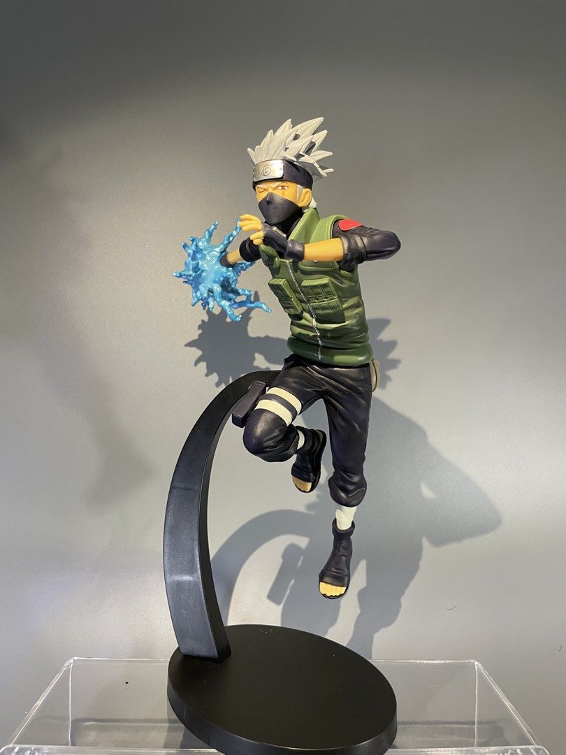 Naruto Hatake Kakashi Chidori Action Figure (Category: Figurines & Statues) located in Calasiao. Submitted by grandshark_635287 (Listing ID 1467300049, Image 1). Description: - Character: Hatake Kakashi from Naruto - Pose: Dynamic mid-air action pose with translucent blue Chidori effect - Details: Features iconic Leaf Village flak jacket, headband, and detailed dark outfit - Stand: Includes a sturdy black curved display stand - Condition: Excelle