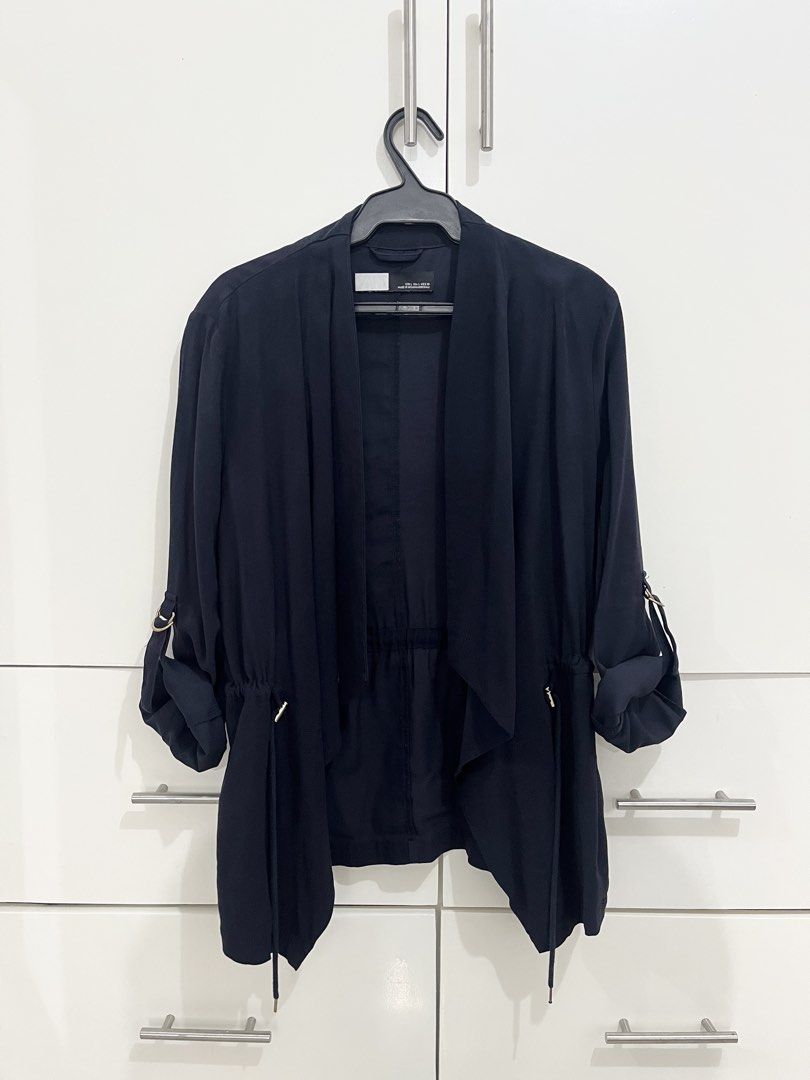 Navy Blue Shawl Blazer (Category: Coats, Jackets and Outerwear) located in Quezon City. Submitted by shoppley (Listing ID 1462954301, Image 1). Description: - Navy blue utility jacket - Drawstring waist for adjustable fit - Roll-up sleeves with tab for securing - Button closure at the front - Ideal for layering over outfits.