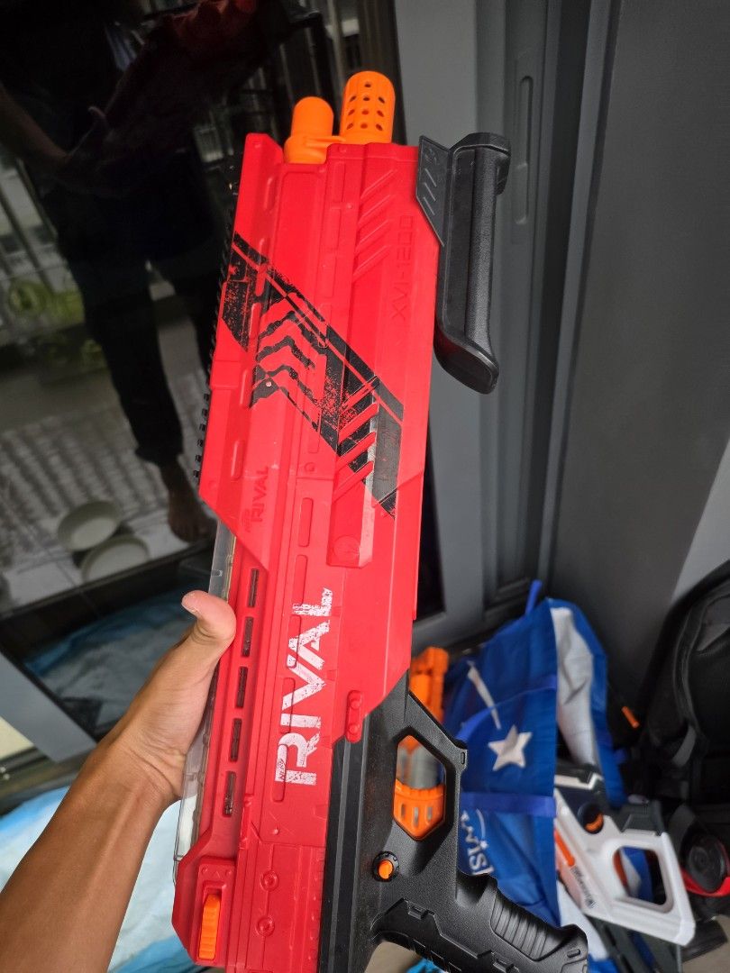 Nerf Rival Blaster Red (Category: Action & Battle Toys) located in Singapore. Submitted by fastearth.887cbb (Listing ID 1467322321, Image 1). Description: - Model: Red Nerf Rival blaster - Design: Pump-action with black handle and top tactical rail - Safety: Orange muzzle tips - Material: Solid, sturdy plastic build - Ideal for: Outdoor target practice and backyard battles - Condition: Great pre-loved condition (Self-collection or meetup availabl