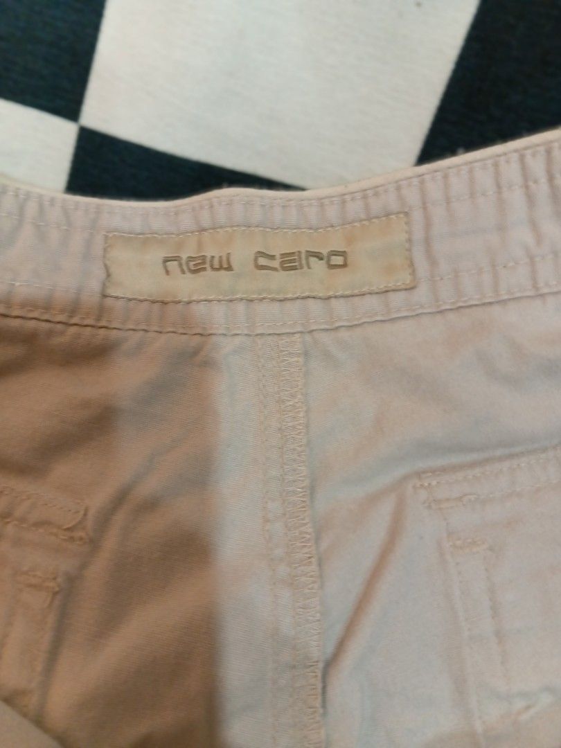 New Man Beige Cargo Shorts (Category: Shorts) located in Manila. Submitted by cami1914 (Listing ID 1467328296, Image 3). Description: - Brand: New Man - Color: Neutral beige - Material: Sturdy cotton fabric - Closure: Zip fly and button - Pockets: Multiple back pockets with button details - Style: Great for casual everyday wear or outdoor activities.
