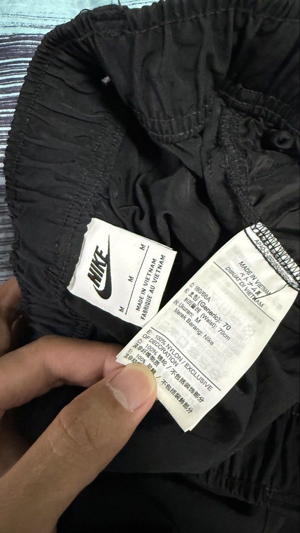 Nike Air Black Nylon Cargo Pants Size M (Category: Joggers) located in Caloocan City. Submitted by kobeeeee_12 (Listing ID 1467226199, Image 3). Description: - Brand: Nike - Color: Black - Size: Medium (Men's/Unisex) - Material: 100% Nylon - Waistband: Elastic with printed branded belt detail - Pockets: Convenient side pockets - Branding: Small Nike Air logo graphic near the left ankle hem - Origin: Made in Vietnam - Condition: Excellent / Ready 