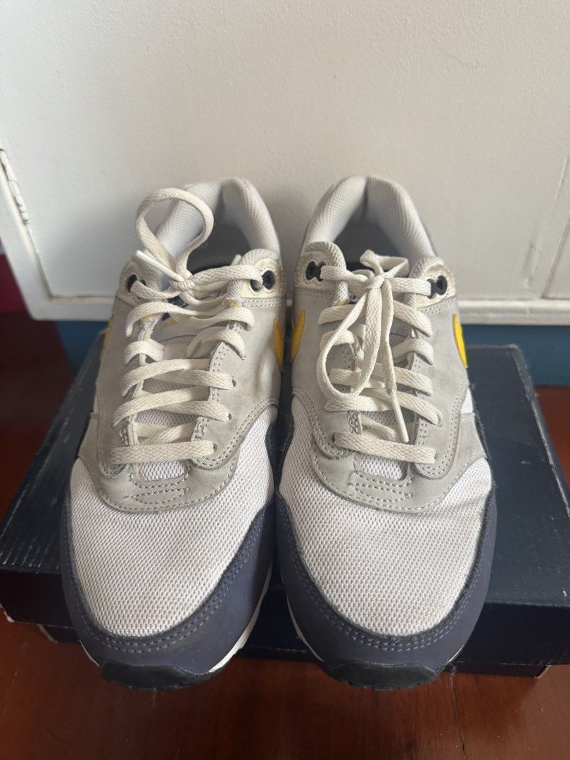 Nike Air Max 1 White Yellow Grey (Category: Babies & Kids Fashion) located in Batangas. Submitted by GDW98 (Listing ID 1467178889, Image 1). Description: - Model: Nike Air Max 1 - Colorway: White mesh base, grey suede overlays, striking yellow swooshes, and dark navy blue mudguard - Details: Gold Nike Air embroidery on the heel, classic visible bubble cushioning in the white midsole - Fit & Style: Comfortable for daily wear with a clean aesthetic