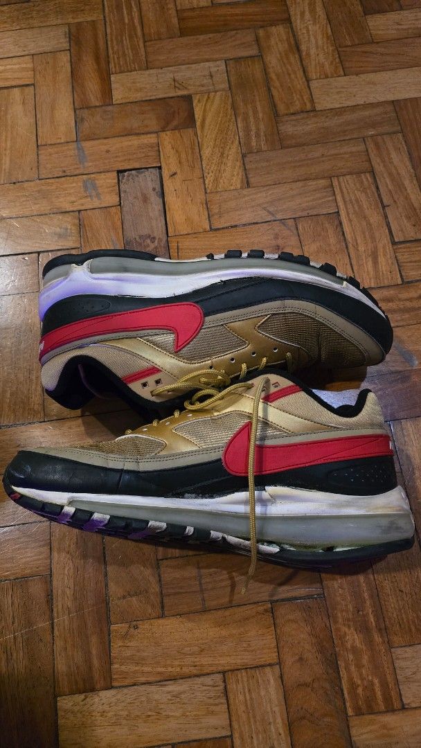 Nike Air Max Gold Red Black Sneakers (Category: Sneakers) located in Pasig City. Submitted by johnflan (Listing ID 1467343003, Image 1). Description: - Colorway: Bold gold, red, and black combination - Upper: Breathable mesh panels with matching gold laces - Branding: Eye-catching red swoosh and white Air Max heel tab lettering - Comfort: Cushioned midsole featuring visible Air units and Nike Air insoles - Outsole: Standard rubber sole with relia