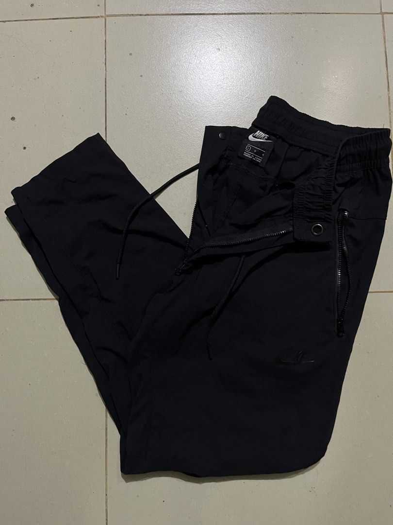 Nike Black Woven Track Pants Size L (Category: Joggers) located in Pasay City. Submitted by Oboyyy (Listing ID 1467253931, Image 1). Description: - Brand: Nike - Color: Black - Size: L - Condition: Clean, no major flaws - Features: Elastic waistband with drawstring, convenient side zip pockets - Origin: Made in China - Versatile: Ideal for workouts or daily casual wear.
