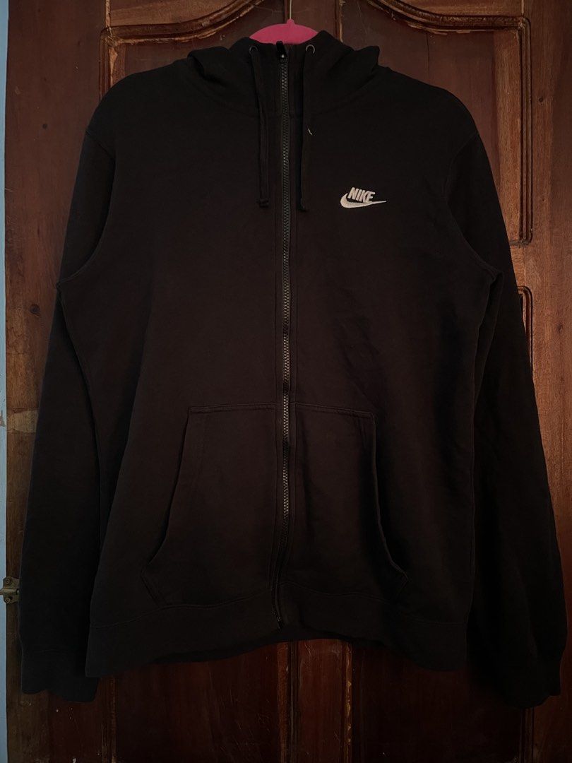 Nike Black Zip-Up Hoodie Size M (Category: Hoodies) located in Davao. Submitted by vin.my (Listing ID 1467204577, Image 1). Description: Black Nike zip-up hoodie with embroidered white logo on the chest. Full zip front, adjustable hood drawstrings, and split kangaroo pockets. Size M tag on the collar, made in Jordan. Interior care label lists style number 804389-010. Cotton blend material, comfortable everyday fit..