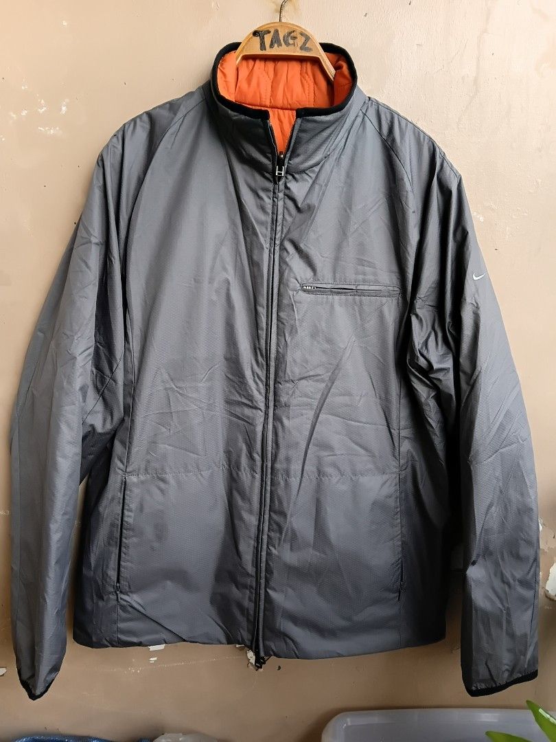 Nike Clima-Fit Reversible Grey and Orange Jacket Size L (Category: Coats, Jackets and Outerwear) located in Manila. Submitted by grandflower-547aee (Listing ID 1467287334, Image 1). Description: - Brand: Nike - Style: Clima-Fit Reversible Jacket (Grey / Vibrant Orange) - Size: L (Made in China) - Material: 100% polyester (outer body, inner body, and fill) - Features: Zip-up front, zipped pockets on both sides, and embroidered Nike swoosh logo - C