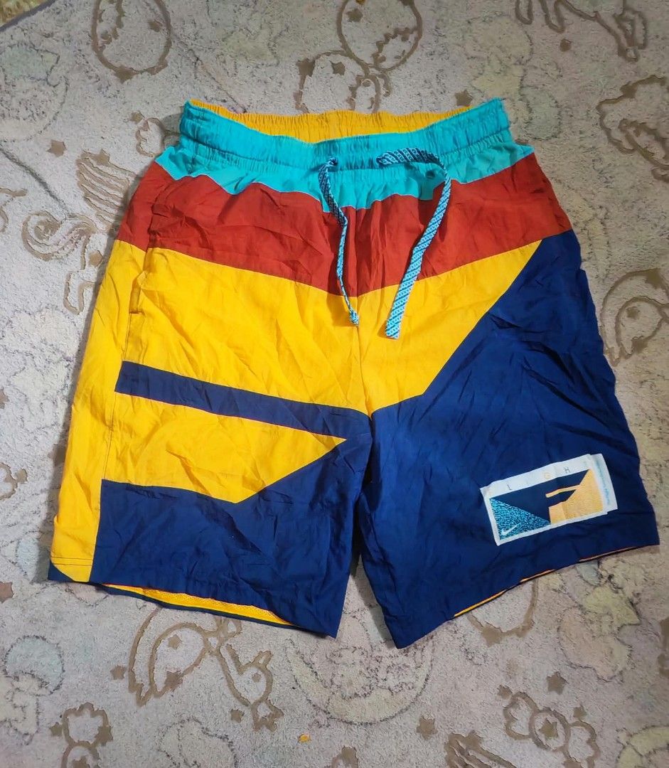 Nike Colorblock Athletic Shorts Multi-Color Drawstring (Category: Shorts) located in Sipalay. Submitted by boldowl.e4f283 (Listing ID 1467217028, Image 1). Description: - Eye-catching retro colorblock design in blue, yellow, red, and turquoise - Comfortable elastic waistband with a blue patterned drawstring - Matching inner mesh lining for breathability - Authentic Nike Flight patch graphic stitched near the right hem - Lightweight nylon material