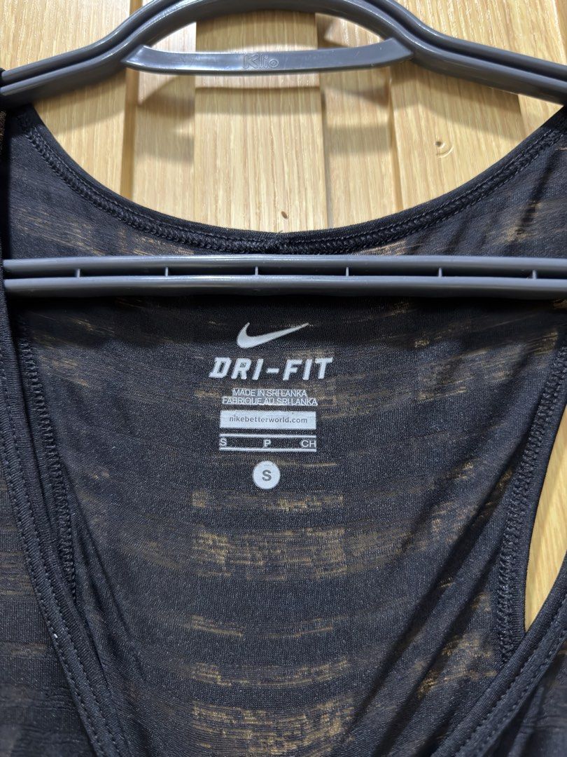 Nike Dri-Fit Black Athletic Tank Top (Category: Activewear) located in Bacoor. Submitted by preloved_with_love_ (Listing ID 1467335598, Image 3). Description: - Brand: Nike - Style: Dri-Fit sleeveless racerback tank top - Color: Black with subtle horizontal stripes - Logo: Silver Nike swoosh on upper chest - Size: S - Origin: Made in Sri Lanka - Details: Comfortable printed inner neck label - Condition: Brand new / Excellent quality.