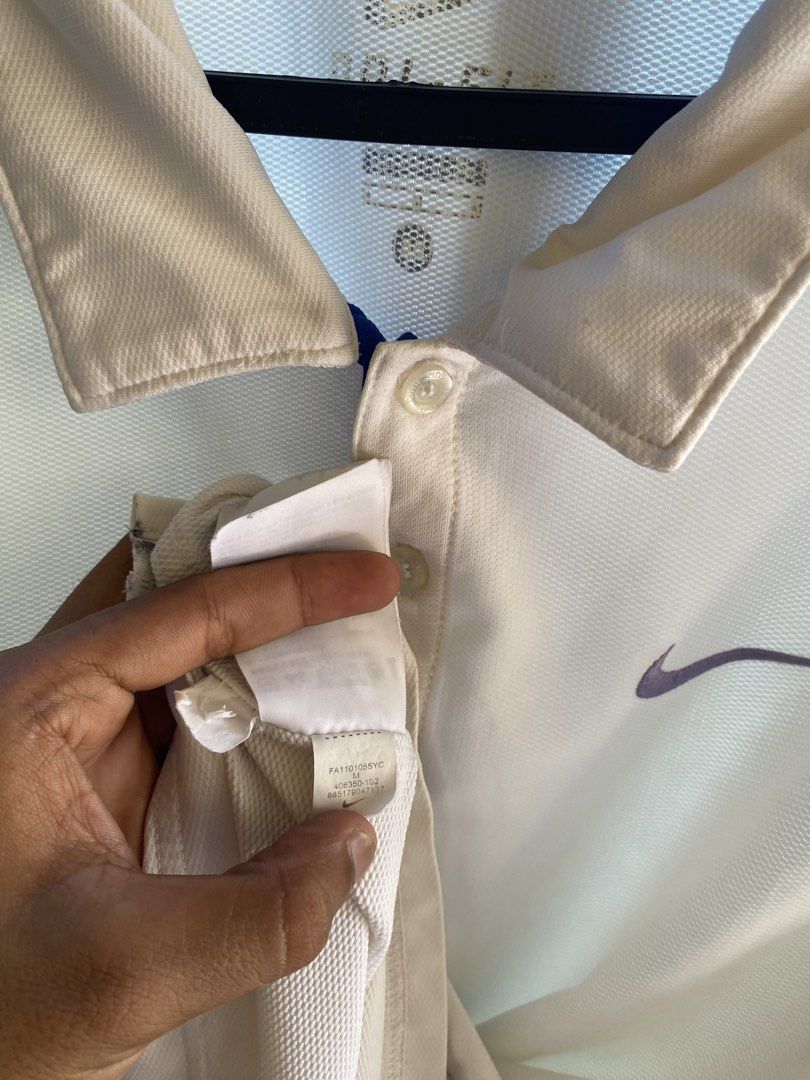 Nike Dri-FIT White Polo Shirt Medium (Category: Tshirts & Polo Shirts ) located in Manila. Submitted by mystic.enrique_romulo (Listing ID 1467192463, Image 3). Description: - Brand: Nike - Style: Dri-FIT Polo Shirt - Color: White with Purple Swoosh logo on left chest - Size: Medium - Material: Breathable mesh fabric - Features: Classic collar with three-button placket - Condition: Excellent / As good as new.