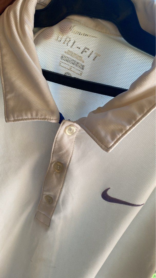 Nike Dri-FIT White Polo Shirt Medium (Category: Tshirts & Polo Shirts ) located in Manila. Submitted by mystic.enrique_romulo (Listing ID 1467192463, Image 2). Description: - Brand: Nike - Style: Dri-FIT Polo Shirt - Color: White with Purple Swoosh logo on left chest - Size: Medium - Material: Breathable mesh fabric - Features: Classic collar with three-button placket - Condition: Excellent / As good as new.