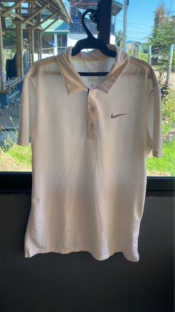 Nike Dri-FIT White Polo Shirt Medium (Category: Tshirts & Polo Shirts ) located in Manila. Submitted by mystic.enrique_romulo (Listing ID 1467192463, Image 1). Description: - Brand: Nike - Style: Dri-FIT Polo Shirt - Color: White with Purple Swoosh logo on left chest - Size: Medium - Material: Breathable mesh fabric - Features: Classic collar with three-button placket - Condition: Excellent / As good as new.