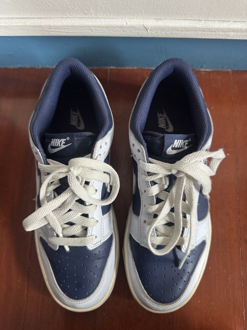 Nike Dunk Low Midnight Navy White Sneakers (Category: Babies & Kids Fashion) located in Batangas. Submitted by GDW98 (Listing ID 1467178695, Image 2). Description: Nike Dunk Low in midnight navy and white colorway. Low-top skate style with classic perforated toe box and chunky laces. White leather panels paired with dark blue overlays. Midsole shows some natural yellowing and scuffs from wear. Tread on the bottom has plenty of grip left. Navy inn