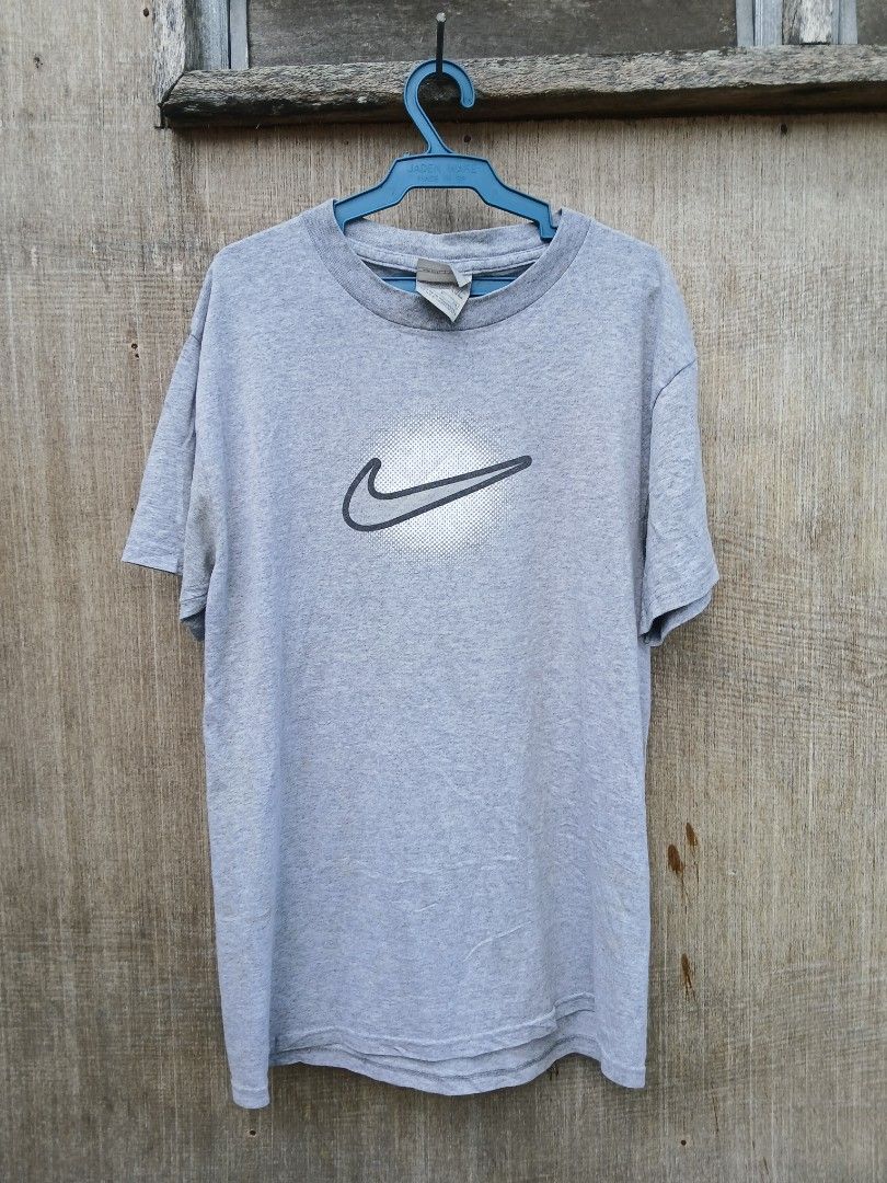 Nike Gray T-Shirt Size S (Category: Shirts) located in Manila. Submitted by thrift_sixty (Listing ID 1467183105, Image 1). Description: - Brand: Nike - Color: Gray with large front swoosh logo - Size: Small - Material: 90% cotton, 10% polyester blend (Made in Honduras) - Style: Short sleeves, crew neck - Condition: Clean, excellent ready-to-wear condition - Perfect for casual, everyday wear.
