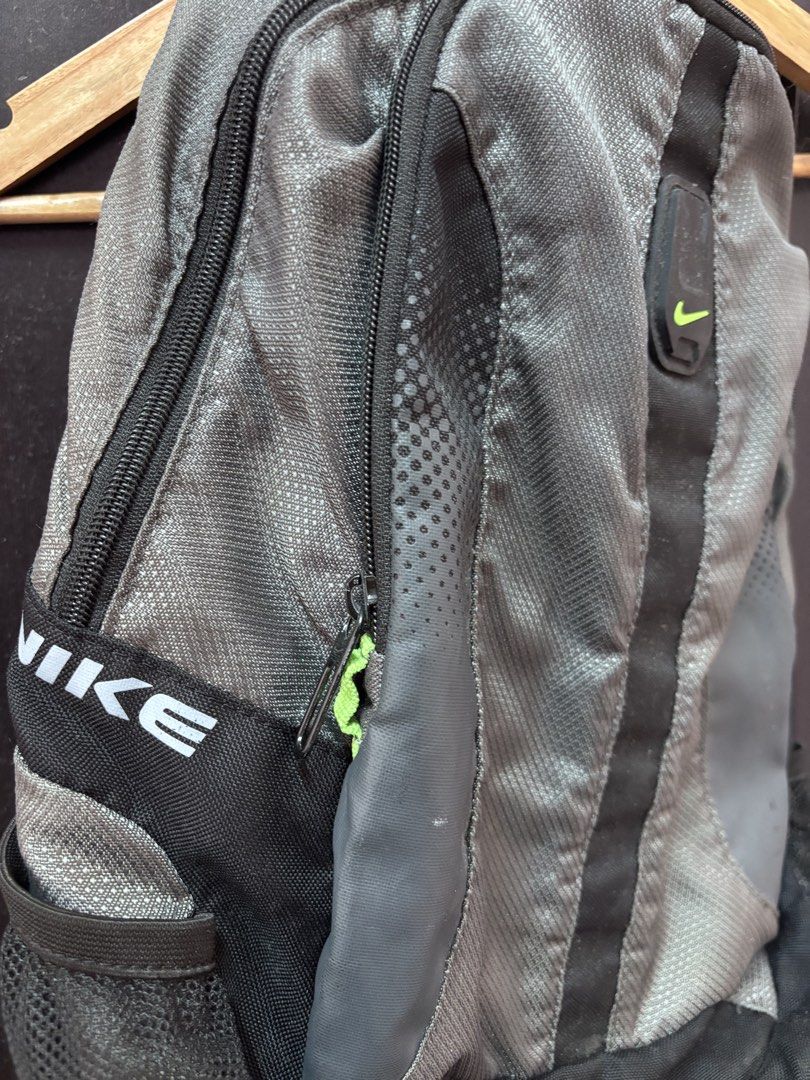 Nike grey and black backpack (Category: Backpacks) located in Quezon. Submitted by vintageshorks (Listing ID 1467199255, Image 2). Description: Vintage nike bag Size Medium - Brand: Nike - Color: Grey and black with lime green zippers and accents - Storage: Main compartment with internal slip pocket and dual mesh side pockets - Comfort: Adjustable shoulder straps - Ideal Use: Great everyday bag for school, work, or the gym.