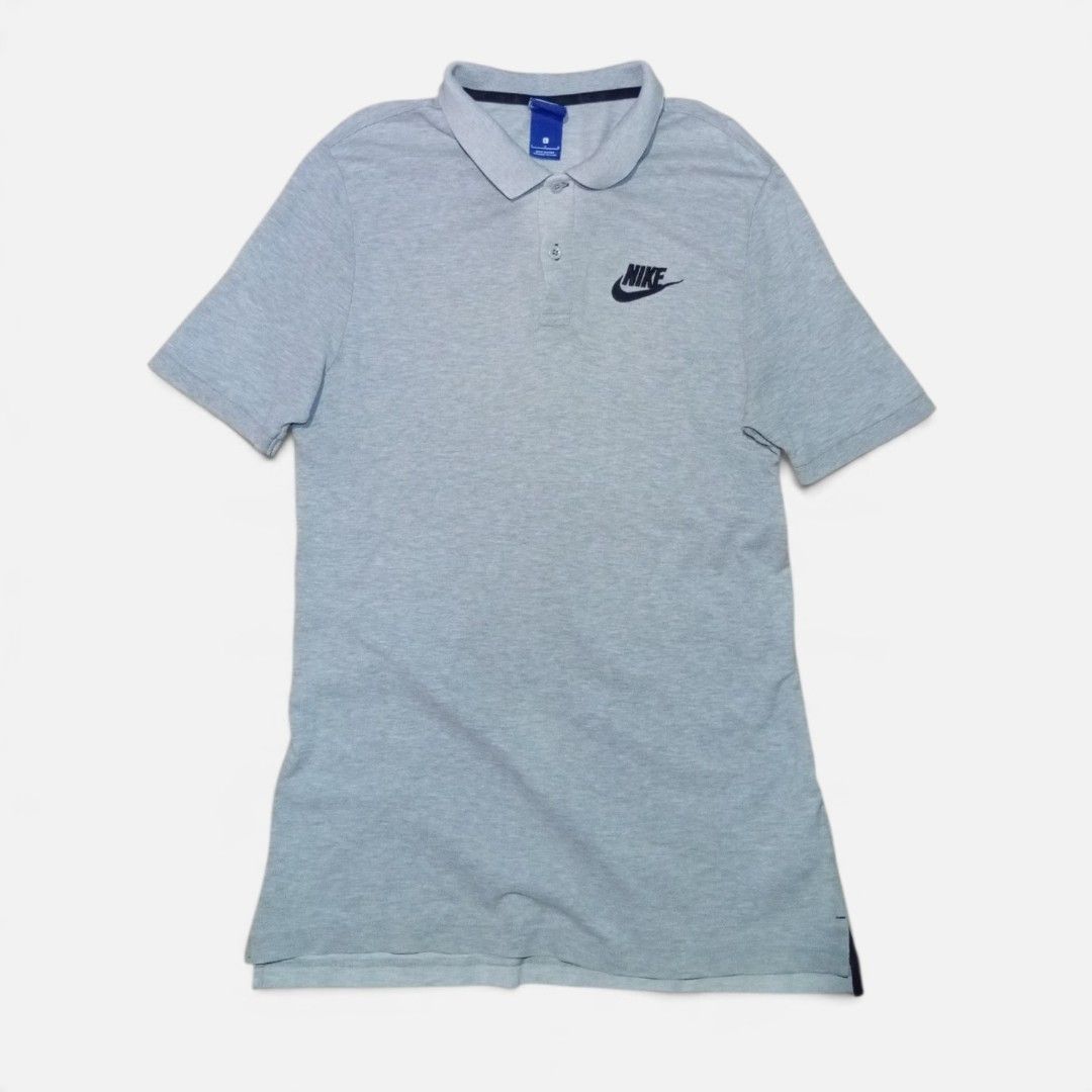 Nike grey polo shirt size L (Category: Tshirts & Polo Shirts ) located in Legazpi City. Submitted by thriftfinds-25 (Listing ID 1467265753, Image 1). Description: - Brand: Nike - Item: Polo Shirt - Color: Grey with contrasting dark inner collar taping - Size: Large (L) slim fit 19x28 - Material: Classic cotton pique fabric - Details: Two-button placket with branded buttons, embroidered black Nike logo on the chest - Origin: Made in China - Condit