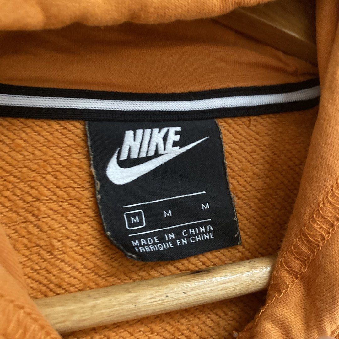 Nike Orange Hoodie Size M (Category: Coats, Jackets and Outerwear) located in Manila. Submitted by seramisu (Listing ID 1467349867, Image 3). Description: - Brand: Nike - Color: Orange with white chest logo - Size: Medium (Made in China) - Fit: Regular - Material: Cotton and polyester blend - Features: Front kangaroo pocket, adjustable drawstring hood - Condition: Great for everyday casual wear.
