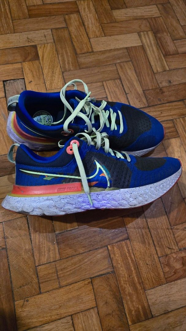 Nike React Infinity Run Flyknit Running Shoes (Category: Sneakers) located in Pasig City. Submitted by johnflan (Listing ID 1467343355, Image 3). Description: - Brand: Nike - Model: React Infinity Run Flyknit - Colorway: Blue and black knit upper with vibrant neon yellow laces and multicolored midsole accents - Sole: Cushioned React foam with textured tread for great grip - Special Detail: 'RUN PAST THE FUTURE' graphic print on the insoles - Cond